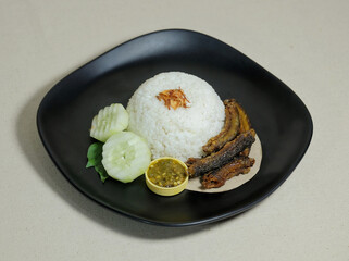 White rice with side dishes fried eel and a little green vegetables served raw. Eels contain animal protein which is rich in nutrients