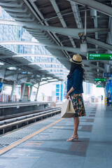 Obraz premium People waiting for the train at subway station. Asian tourist women staying on a line and waiting to board the train