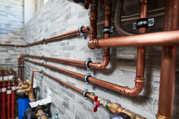 Plumbing service. copper pipeline of a heating system in boiler room - obrazy, fototapety, plakaty