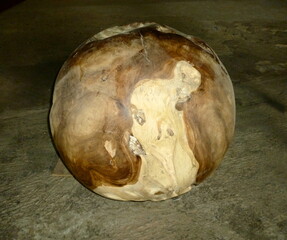 Old natural wooden ball in the darkness