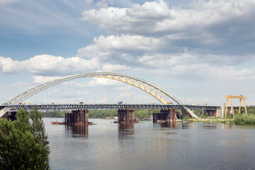 Construction of a new arch bridge across the Dnipro (Dnieper) River, Kyiv, Ukraine. Large infrastructure facility on the water