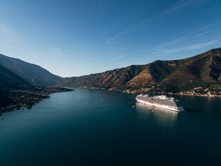 Cruise liner at dawn in Kotor Bay, near the old town of Kotor in Boka Kotorska, Montenegro.