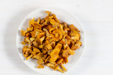 bowl of fresh  chanterelle
 mushrooms on white table