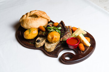 Mixed grilled meats and sausages served on wooden board