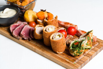 Mixed meats andvegetalbes served on wooden board