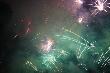 Kuala Lumpur, Malaysia – January 1, 2020: Colourful Fireworks spark during New Year at the Kuala Lumpur City. The image contains certain grain or noise and soft focus.