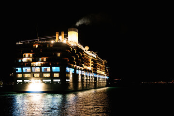 Fototapeta na wymiar Close-up of a cruise liner in the sea at night. Night lighting of the ship.