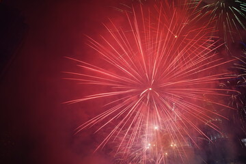 Kuala Lumpur, Malaysia – January 1, 2020: Colourful Fireworks spark during New Year at the Kuala Lumpur City. The image contains certain grain or noise and soft focus.