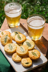 Salty shortbread cookies with sage and beer on a wooden stool.