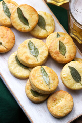 Salty shortbread cookies with sage and beer on a wooden stool.