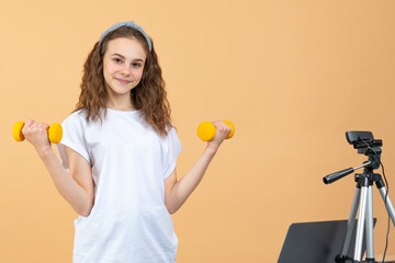 Strong confident beautiful fitness teen girl giving fitness advice on her vlog