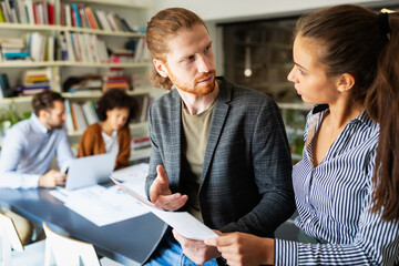 Business people, architects having discussion and working in office