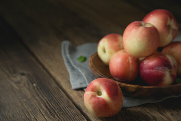 Ripe peaches on a wooden table