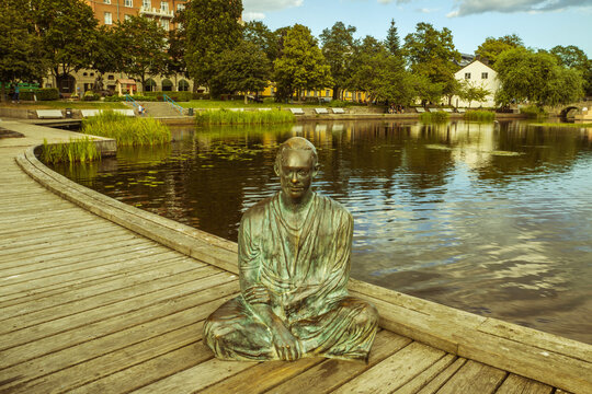 Bronze Buddha statue on the shore of the lake.