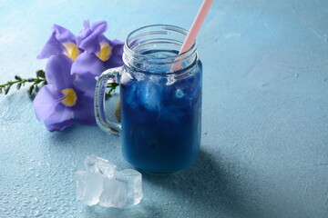Iced butterfly pea latte. Healthy summer cold beverage, iced organic blue and violet butterfly pea flower tea 