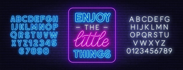 Enjoy the little things neon quote on a brick wall. Inspirational glowing lettering. Neon alphabet on brick wall background.