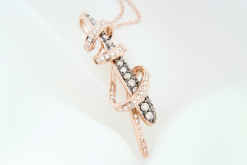 Rose Gold Pendant With Diamonds On Soft White Background