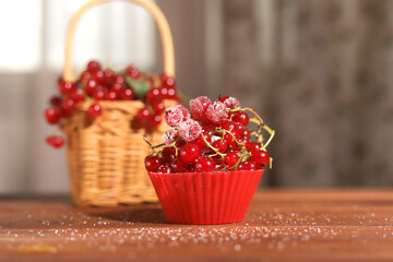 cupcake red currant on a background of currants in a basket