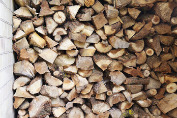 Preparation of firewood for the winter. Stacks of firewood at the home. Pile of firewood. Firewood background. 