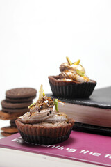 Homemade choco tart or mufins served with whipped cream,chocolate and dryfruits.