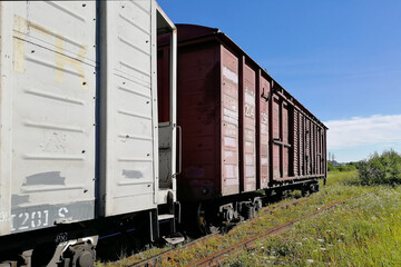 Fototapeta na wymiar Rail cars on rails. Pictured along. Clear skies and a sunny day. A horizontal perspective.