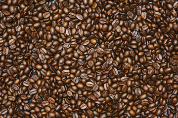 Top view of brown roasted coffee beans, can be use as background, copy space for text.