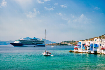 Naklejka premium Scenic Little Venice houses in Chora Mykonos town with yacht and cruise ship. Mykonos island, Greecer