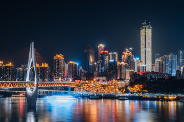 Fototapeta na wymiar High-view night view of Chongqing Grand Theater and tall buildings in China