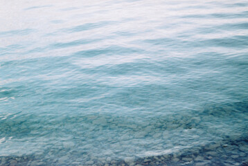 Clear water and waves in summer at dusk on a pike lake in Buryatia