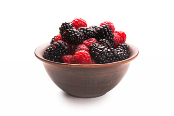 Raspberry, blackberry and mint leaf in ceramic brown bowl isolated on white