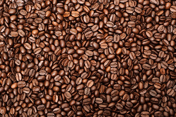 Top view of brown roasted coffee beans, can be use as background, copy space for text.