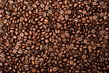 Top view of brown roasted coffee beans, can be use as background, copy space for text.