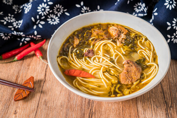 Beef noodles with sauerkraut in old altar on wooden table