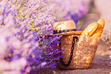 Closeup straw bag and hat in lavender field