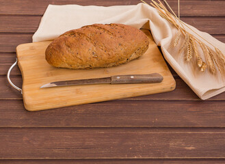 bread plank knife and colossus on a wooden background