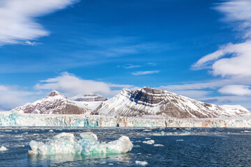 Iceberg, glacier and the Three Crown mountains of Kongsfjorden, Svalbard