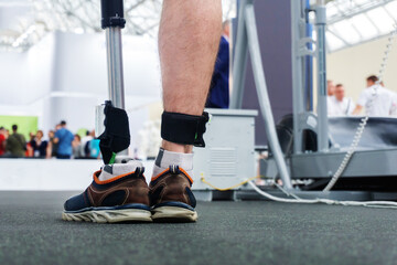 Trying on a bionic leg. An installed sensor for checking the correct pitch of a new product. Testing a modern prosthesis in a technological laboratory. Close-up. Cropped frame