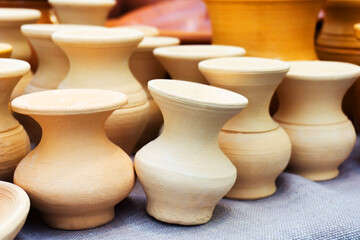 Fototapeta na wymiar Clay pots. Ceramics in a pottery workshop. Trade in clay items.