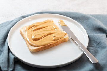 Peanut butter with bread on the table