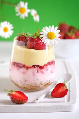 Delicious strawberry dessert with granola, yogurt and vanilla cream. Concept of healthy eating