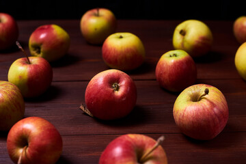 Fresh red-green apples on a wooden background.