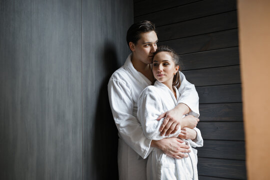 young couple in white robes at the hotel hugs. wedding photo session