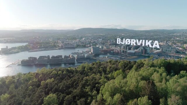 Aerial view of urban Oslo cityline with 3D inscription title Bj&oslash;rvika behind Barcode buildings
