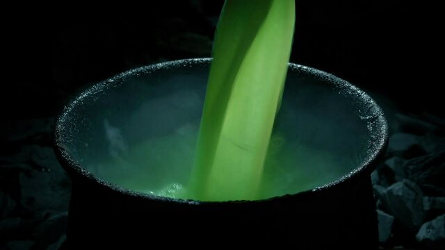 Green Potion Poured Into Goblet Starts Bubbling And Smoking