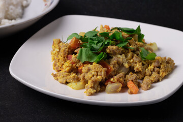 Stir-fried minced pork curry powder in a white plate