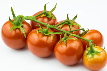 Fresh cherry tomatoes close-up isolated on white background.