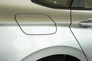 Obraz na płótnie Canvas side rear of a new car in a showroom. rear side door, door handle and gas cap