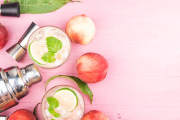 Summer cold alcohol beverage, iced peach Bellini cocktail with mint leaves,