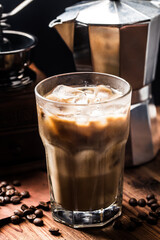 close up view of ice cubes in cold brewed coffee in glass on dark background