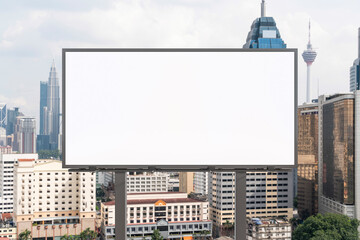 Blank white road billboard with KL cityscape background at day time. Street advertising poster, mock up, 3D rendering. Front view. The concept of marketing communication to promote or sell idea.